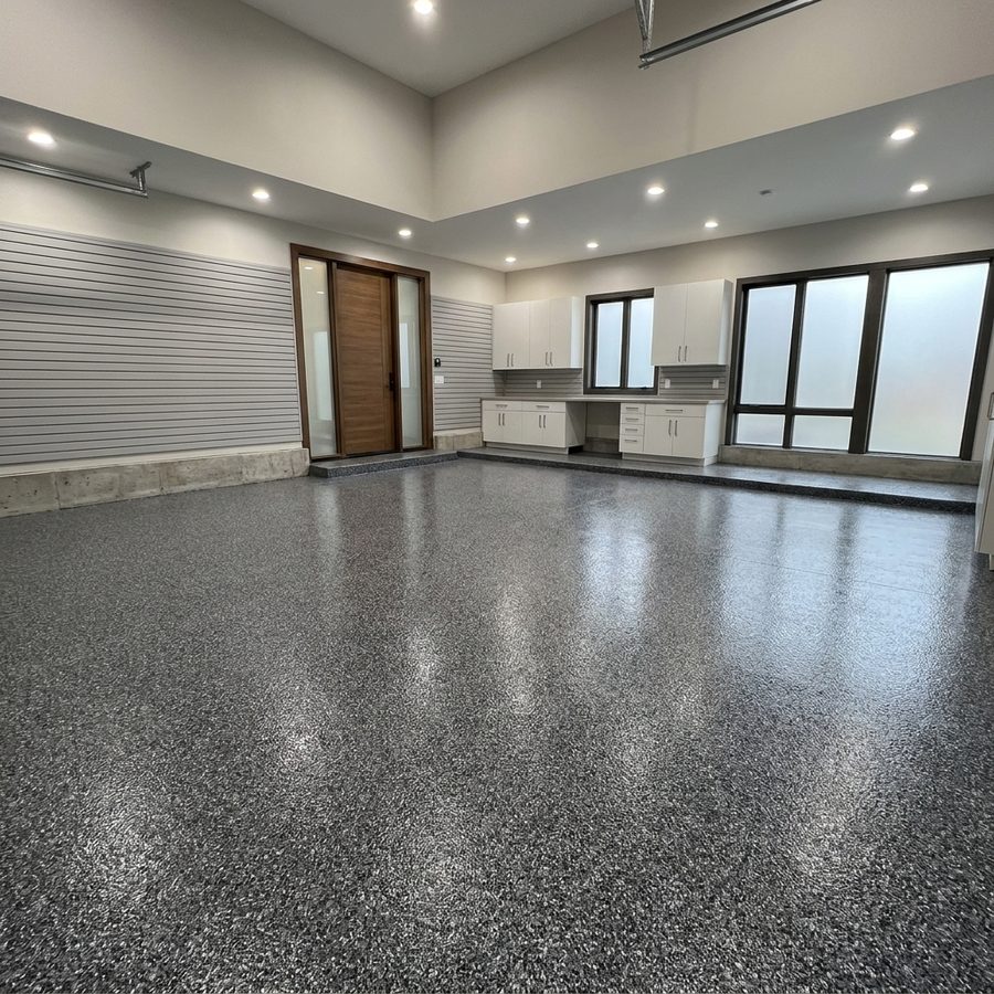Flake epoxy garage floor coating with white cabinetry